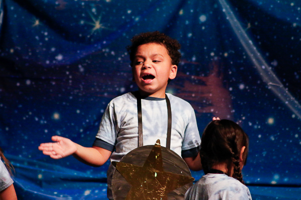 A performer dressed as a start sings