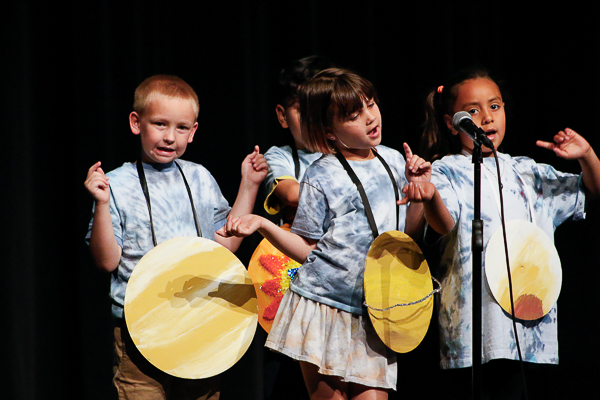 Performers dressed as planets