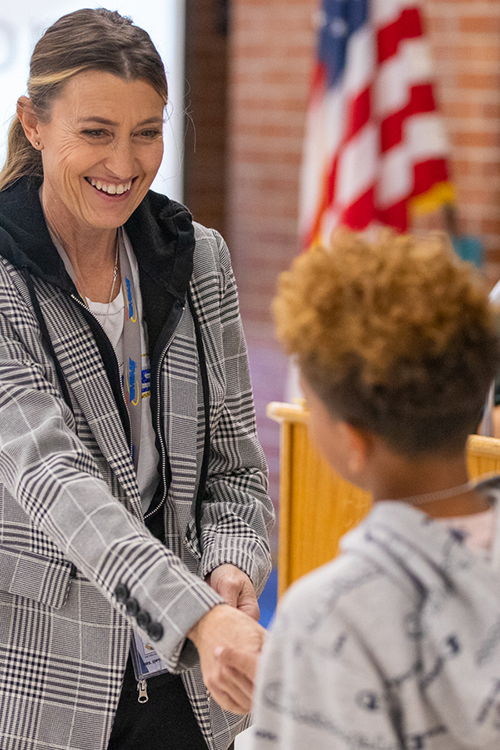 Teacher congratulating student